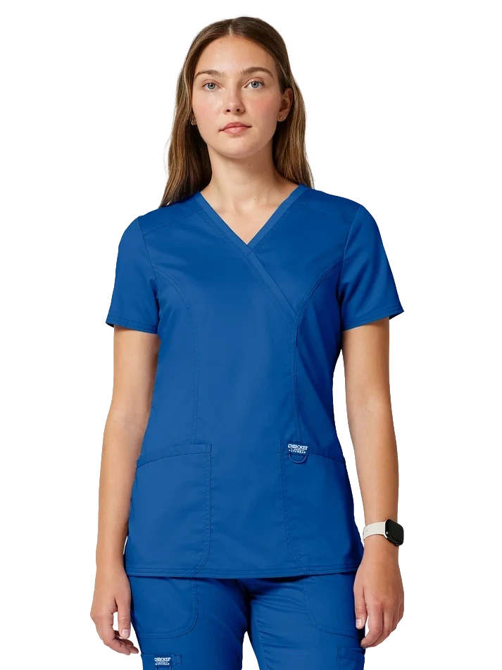 Female supplier model wearing royal blue Cherokee scrubs
